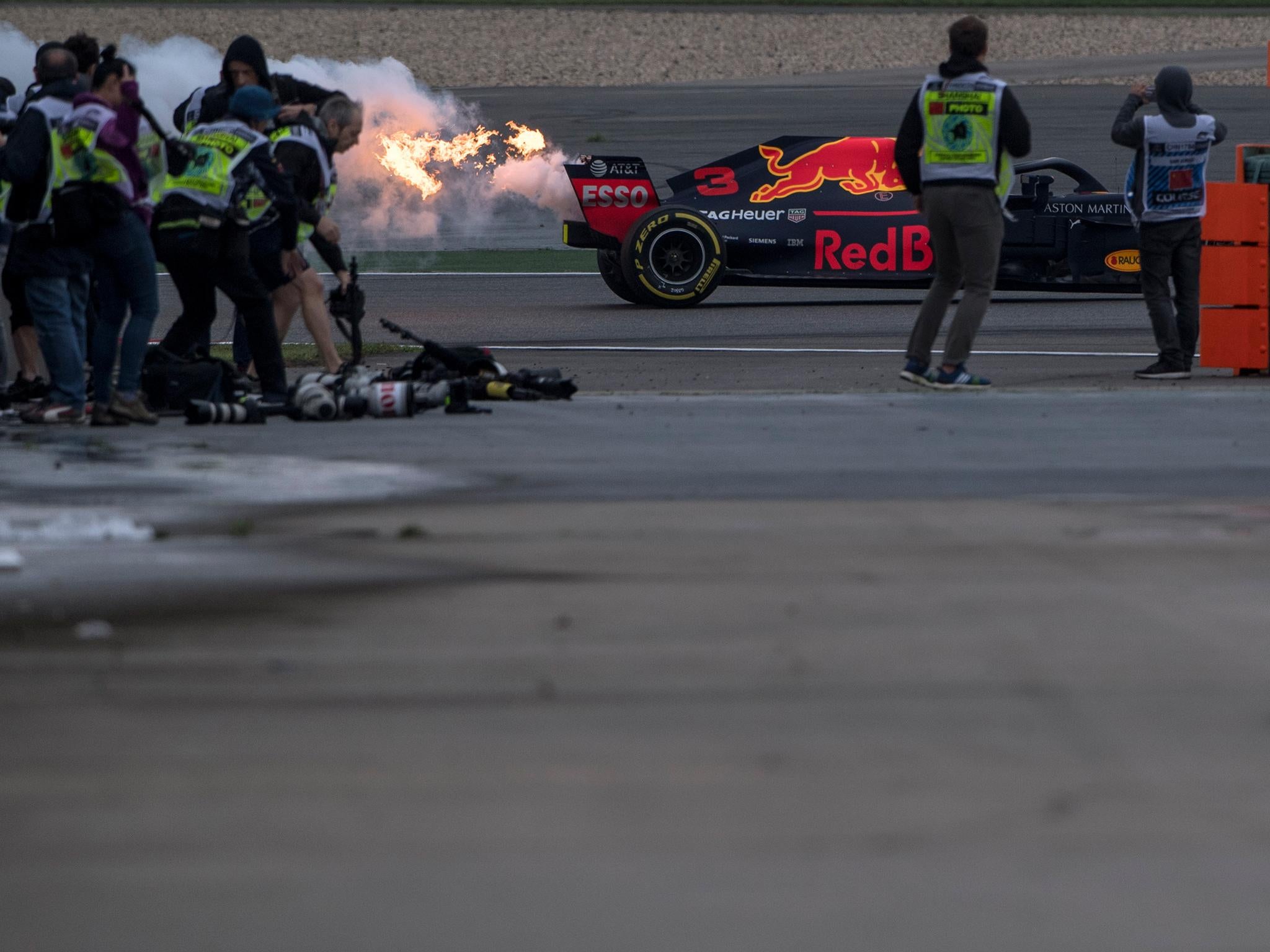 Flames shoot out the back of Ricciardo's Red Bull after its Renault engine blows up