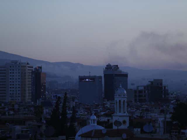 Smoke rises after airstrikes targeted different parts of the Syrian capital Damascus
