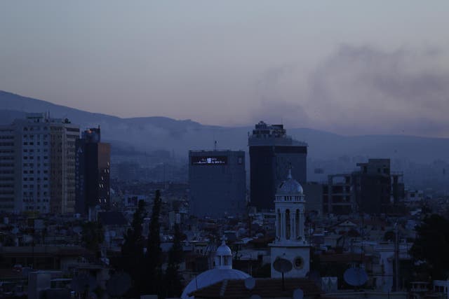 Smoke rises after airstrikes targeted different parts of the Syrian capital Damascus