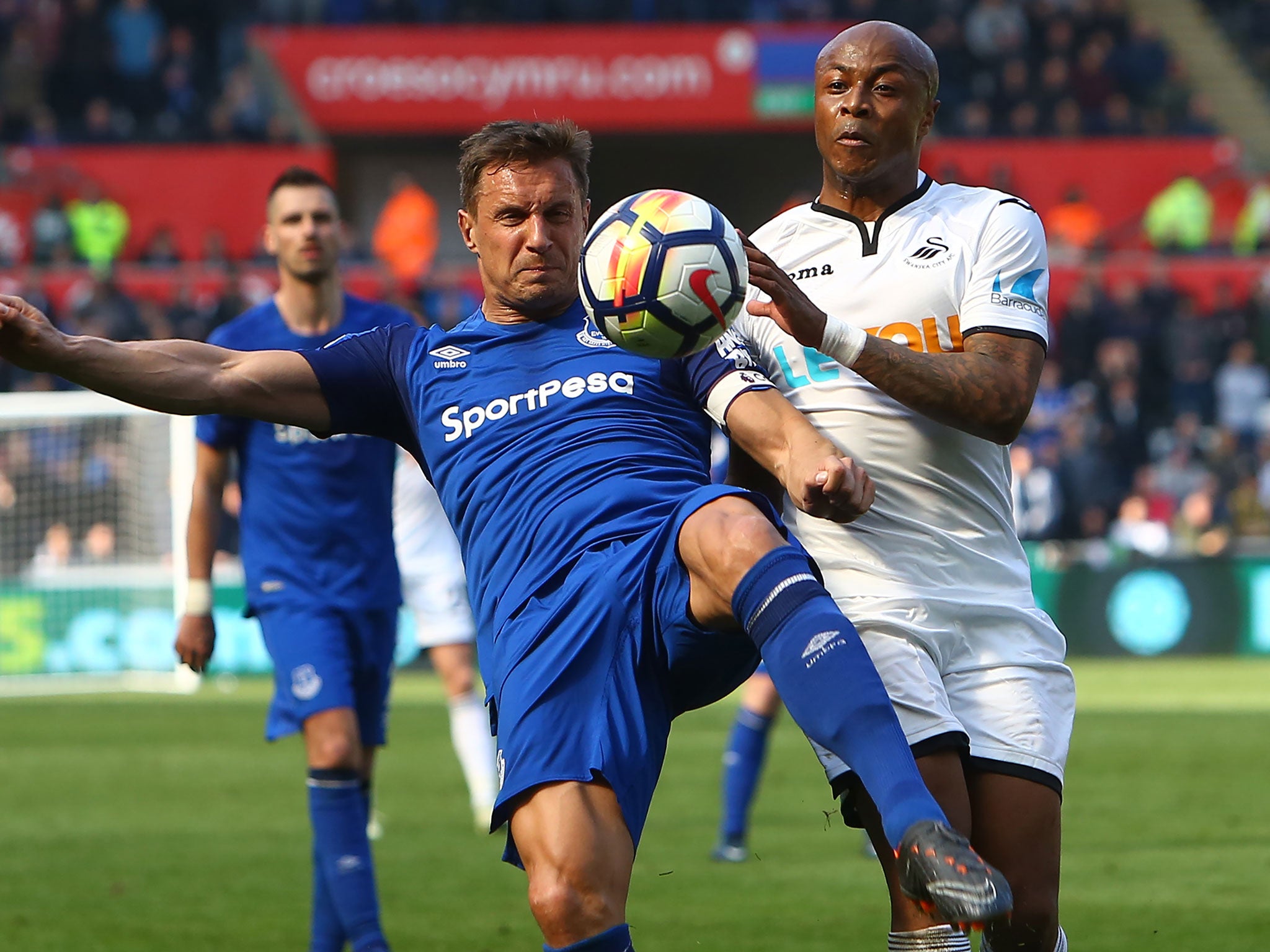 Andre Ayew and Phil Jagielka vie for possession