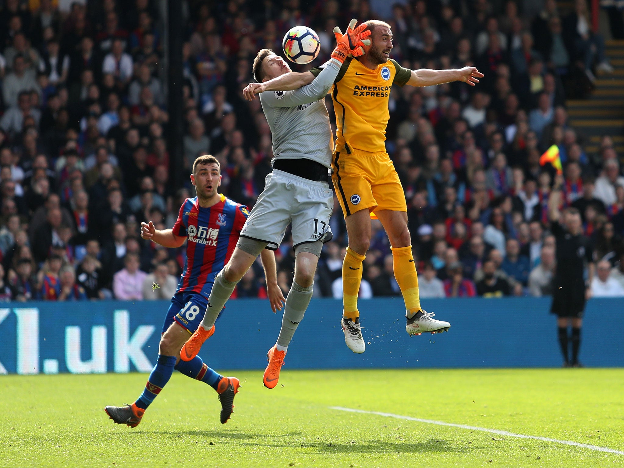 Wayne Hennessey and Glenn Murray compete for a high ball