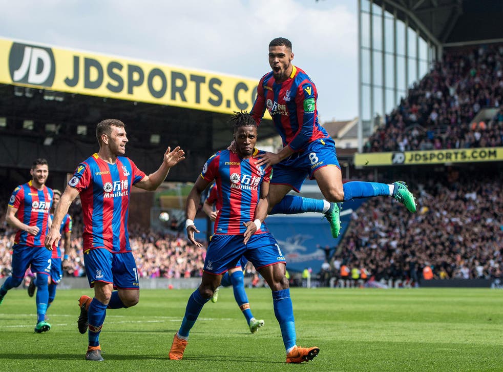 Wilfried Zaha celebrates with his teammates after scoring Palace's third