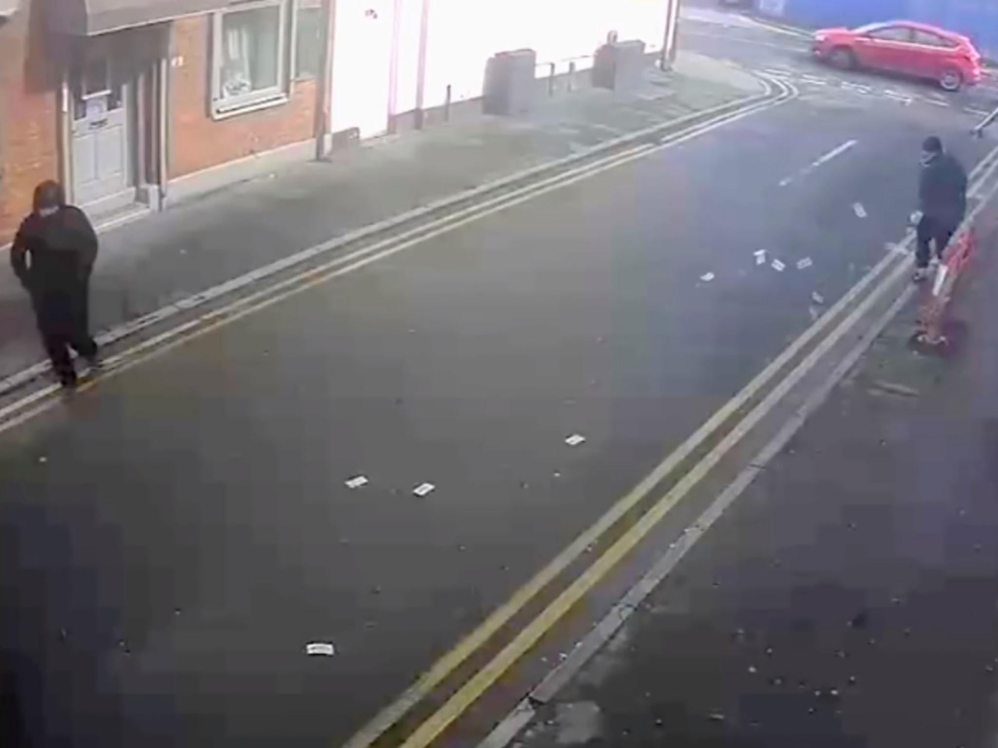 The thieves were seen scrabbling for the notes before they escaped in a silver car.