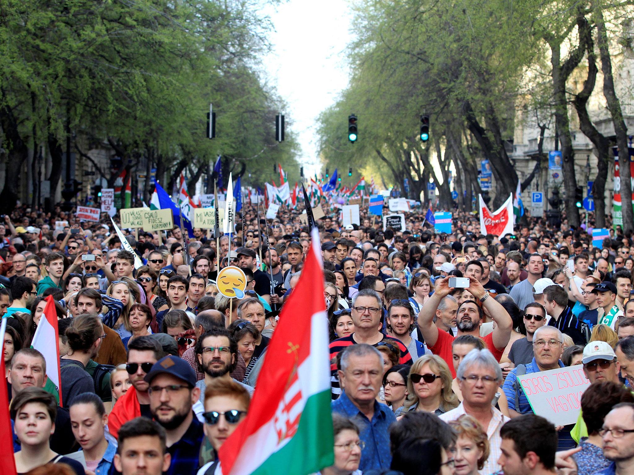 People attend a protest against the Hungarian government in Budapest on 14 April