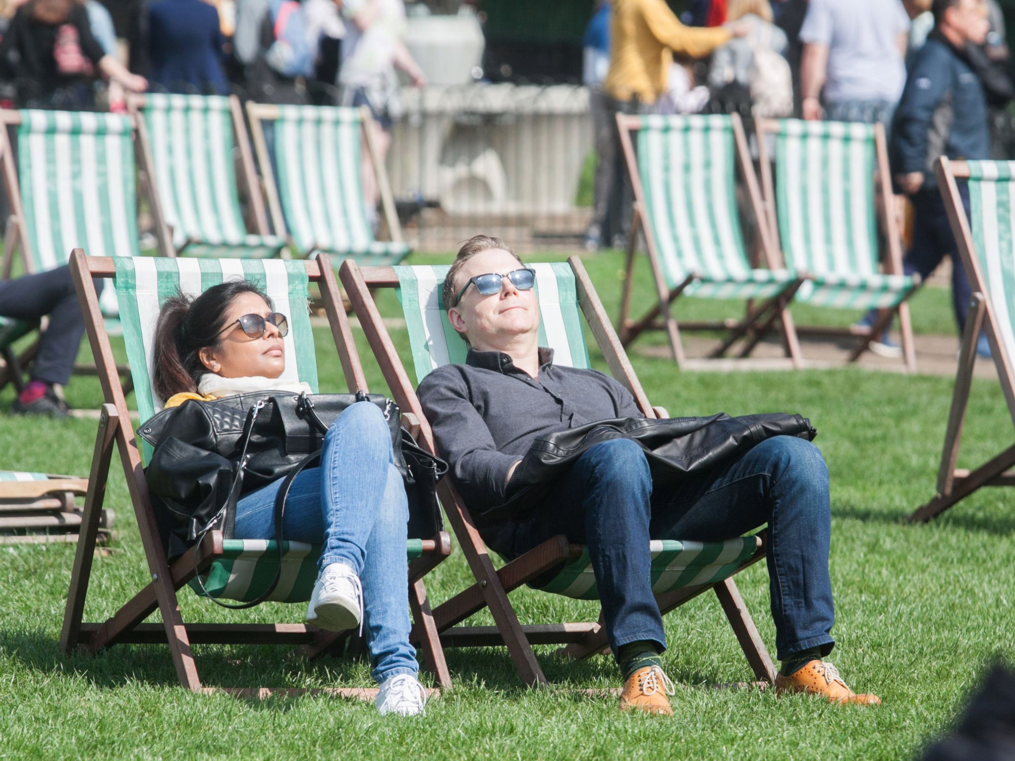 People relaxing in the spring sunshine on Saturday in Green Park London