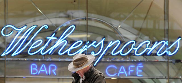 A Wetherspoon's logo is seen at a bar in central London