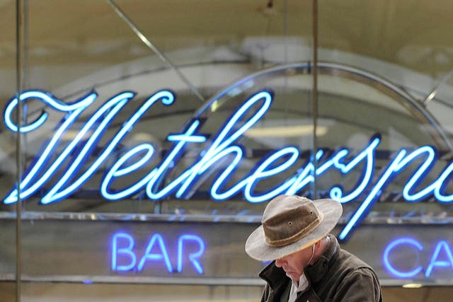 A Wetherspoon's logo is seen at a bar in central London
