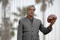 David Byrne opens Coachella set sitting at a table holding up a brain