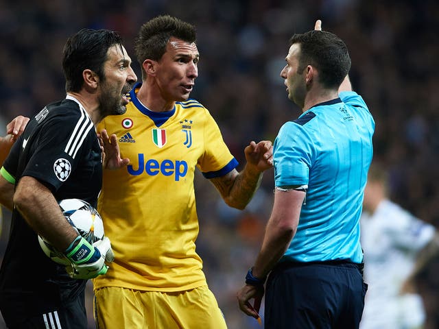 Gianluigi Buffon confronts Michael Oliver after his side conceded late penalty in their Champions League quarter-final tie against Real Madrid