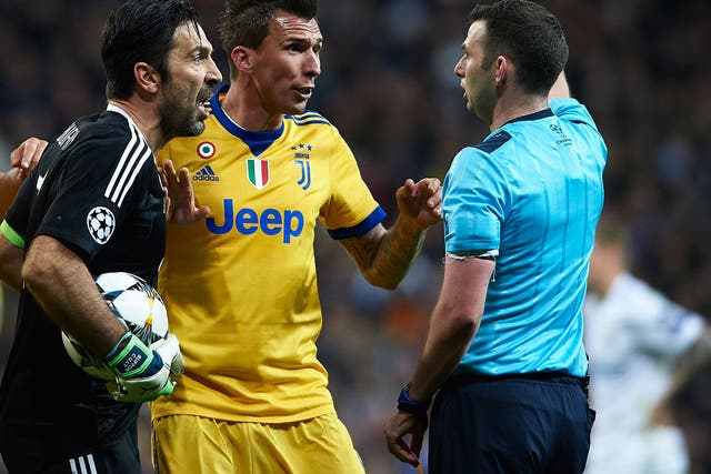 Gianluigi Buffon confronts Michael Oliver after his side conceded late penalty in their Champions League quarter-final tie against Real Madrid