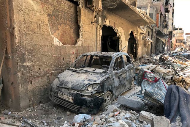 Rubble lines a street in Douma, at the site of a suspected chemical weapons attack in April 2018