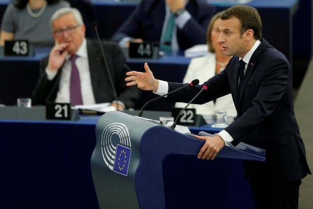 Emmanuel Macron speaks in the European parliament on Tuesday as Jean-Claude Juncker watches on