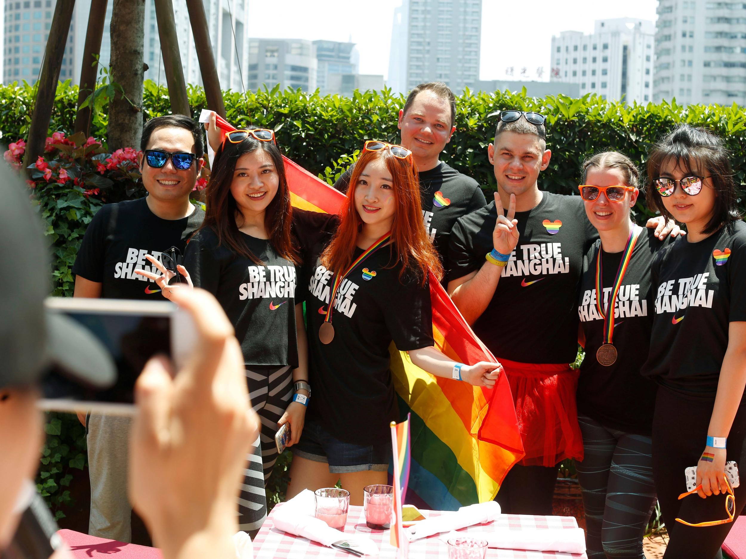 A group poses for photos after taking part in the Pride Run in Shanghai in June 2017