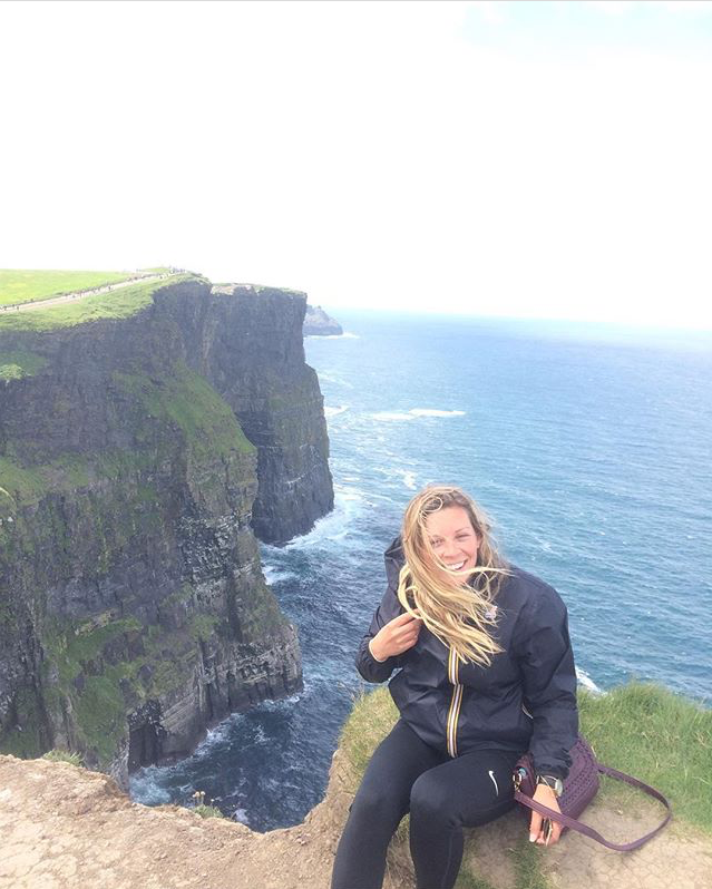 Nicole Enriquez sits on the Cliffs of Moher in Galway, Ireland