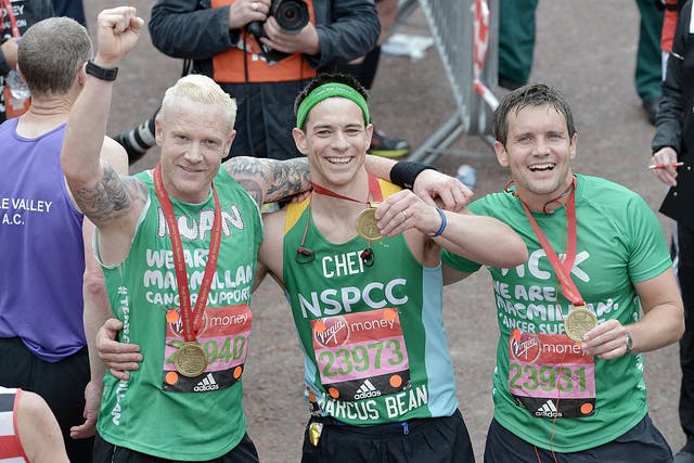 Iwan Thomas, Marcus Bean and Jack Ashton pose with their medals after completing the Virgin Money London Marathon on April 24, 2016