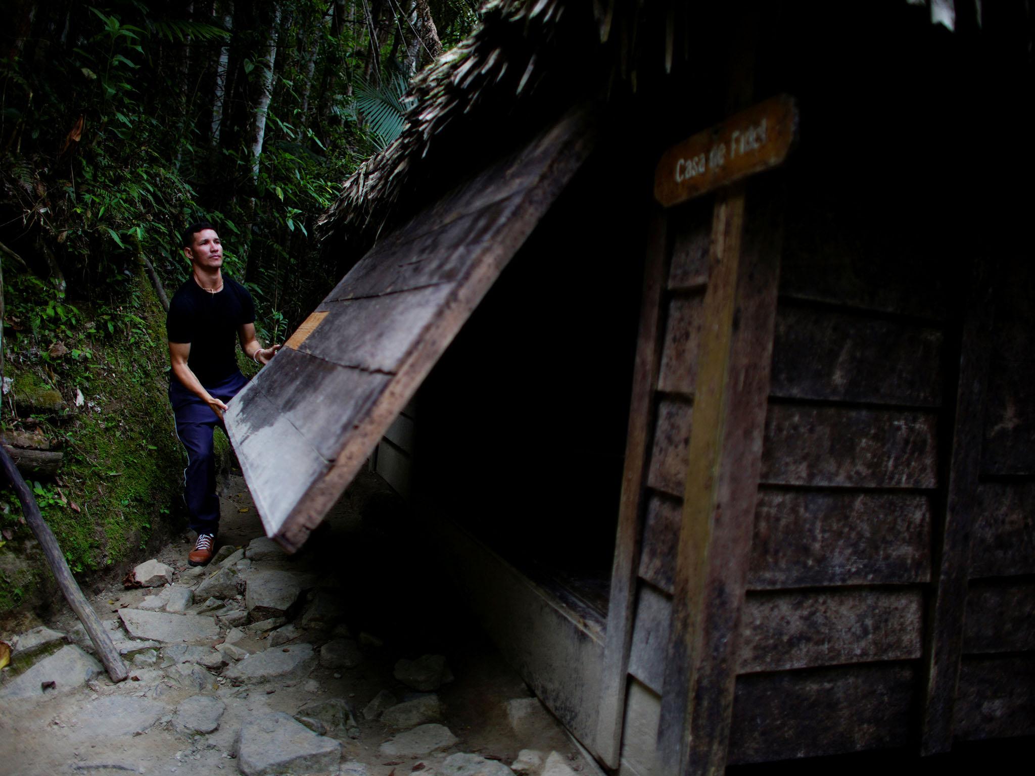 Local official guide Luis Enrique Perez closes a window of the house where the late President, Fidel Castro, lived during the Cuban revolution (Reuters)