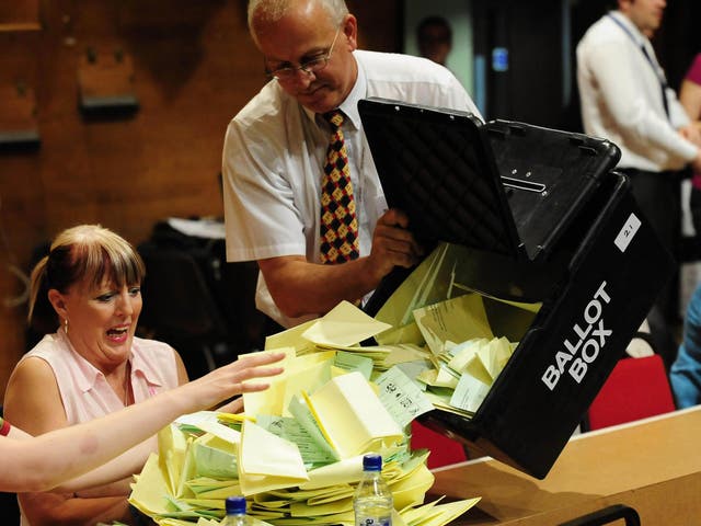 Local election ballot papers are emptied from a ballot box before being sorted and counted in Preston