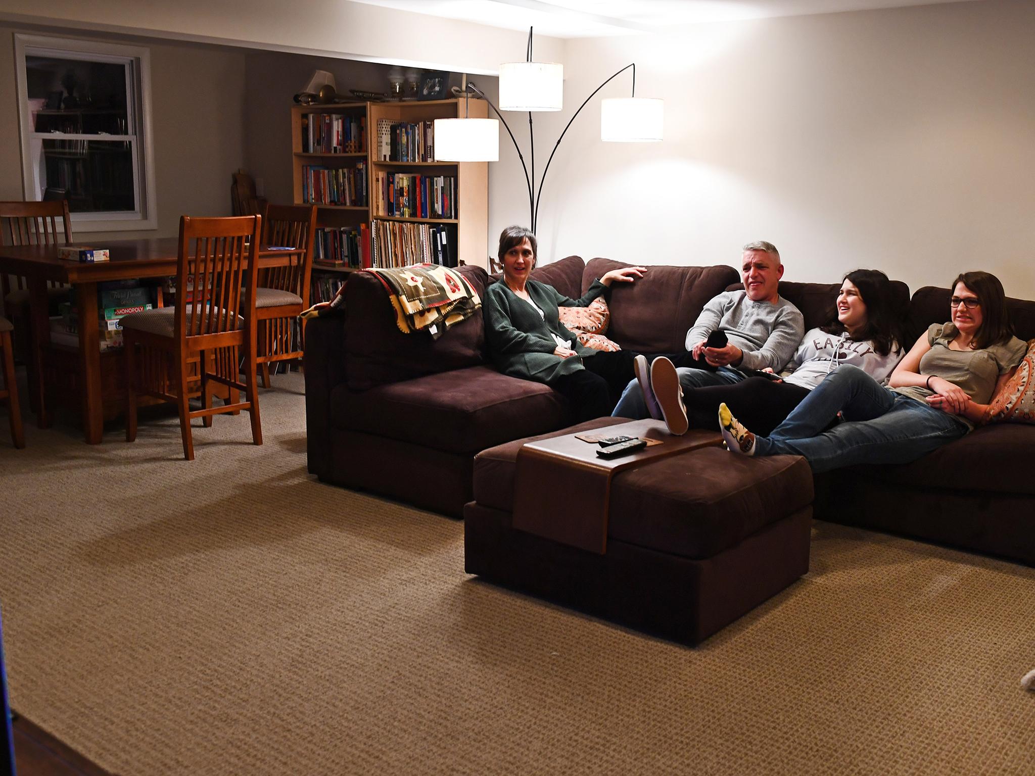 Lisa, Rusty and the girls spend time together watching TV in their basement family room