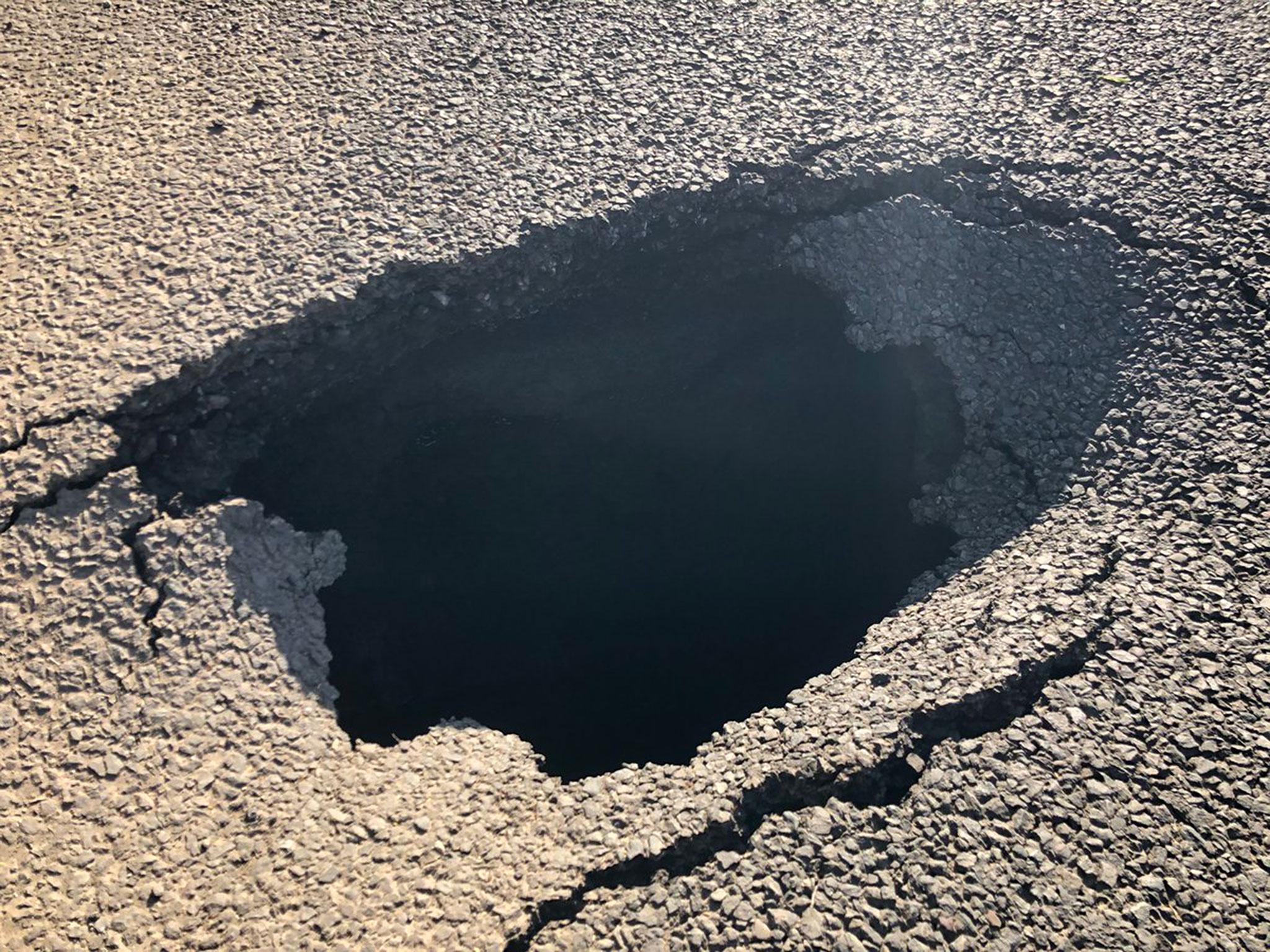 Sinkhole opens up in middle of A40 in Wales, causing it to close in both directions