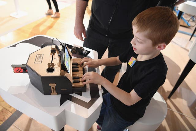 In this photo provided by Nintendo of America, kids enjoy playing tunes on a Toy-Con Piano at an exclusive event in New York on Feb. 2, 2018
