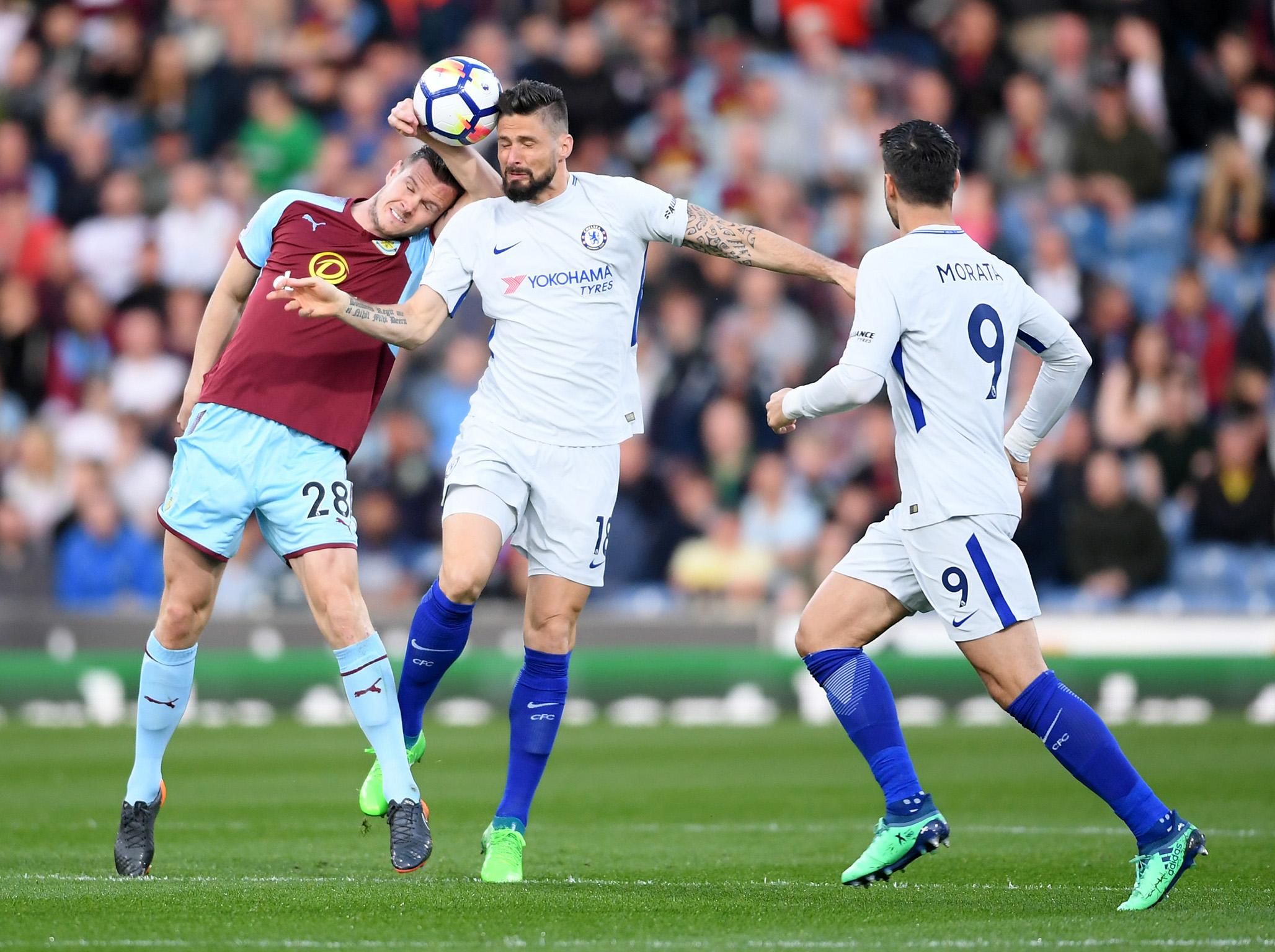 Olivier Giroud battles Kevin Long for the ball