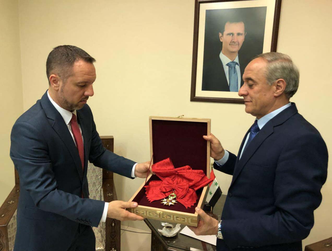 Bashar al-Assad's Legion d'honneur award is handed back to France via the Romanian embassy