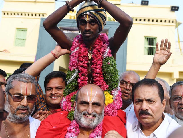 Hindu priest CS Rangarajan carries Dalit devotee Aditya Parasri on his shoulders