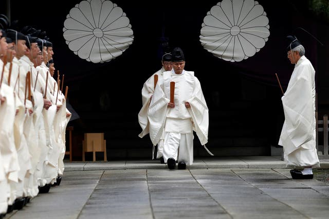 Japanese Shinto priests attend a ritual during an autumn festival at Yasukuni Shrine in Tokyo