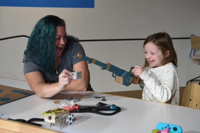 In this photo provided by Nintendo of America, kids enjoy making a Toy-Con Fishing Rod at an exclusive event in New York on Feb. 2, 2018