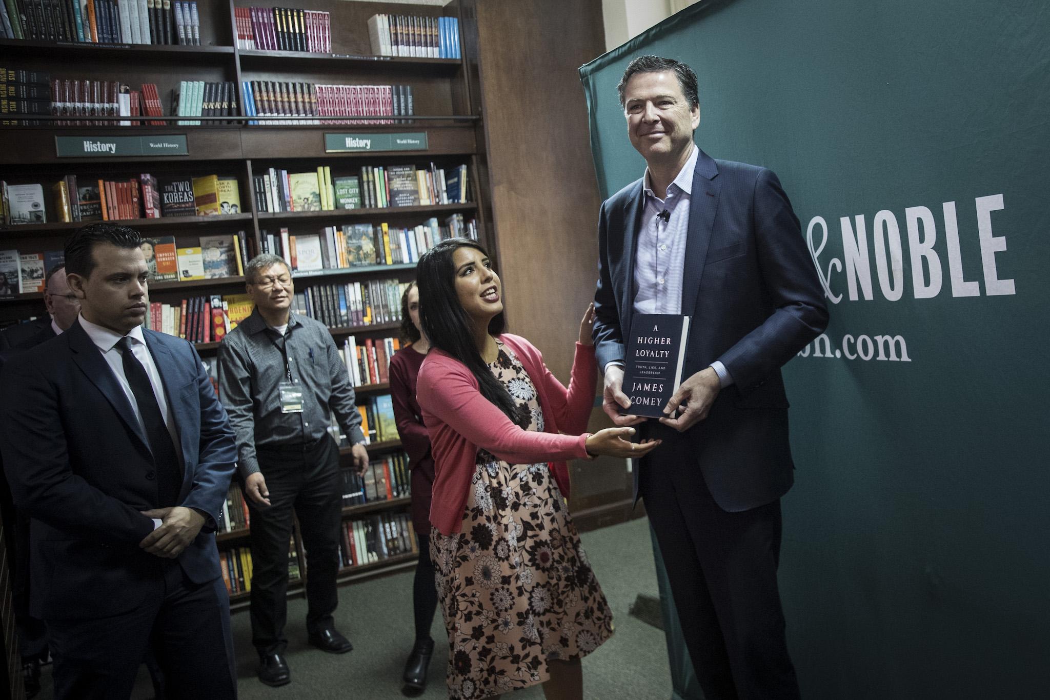 Former FBI Director James Comey poses for photographs as he arrives to speak about his new book "A Higher Loyalty: Truth, Lies, and Leadership" in New York