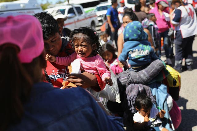 A child in the migrant caravan traveling through Mexico cries