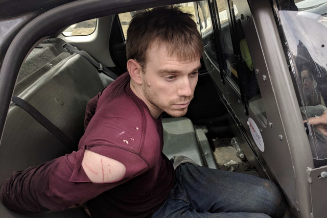 Police said they apprehended shooting suspect Travis Reinking in a wooded area