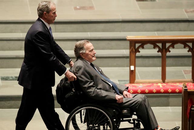 Former president George HW Bush is pushed by his son, former president George W Bush, during funeral services for former first lady Barbara Bush in Houston, Texas
