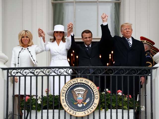 President Donald Trump, French President Emmanuel Macron, first lady Melania Trump and Brigitte Macron hold hands on the White House balcony during a State Arrival Ceremony in Washington.