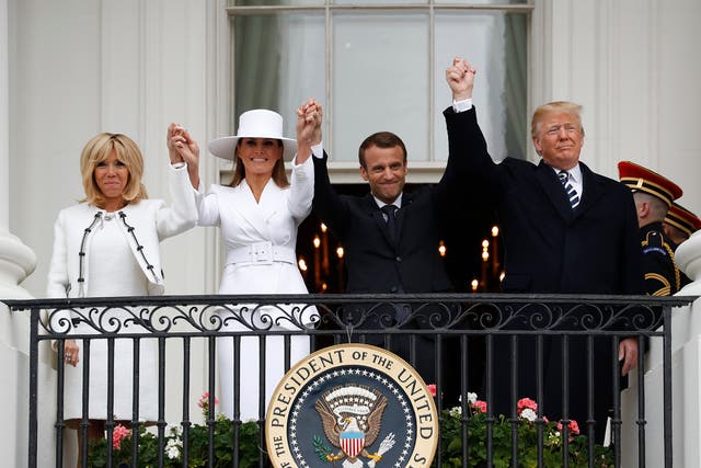 President Donald Trump, French President Emmanuel Macron, first lady Melania Trump and Brigitte Macron hold hands on the White House balcony during a State Arrival Ceremony in Washington.