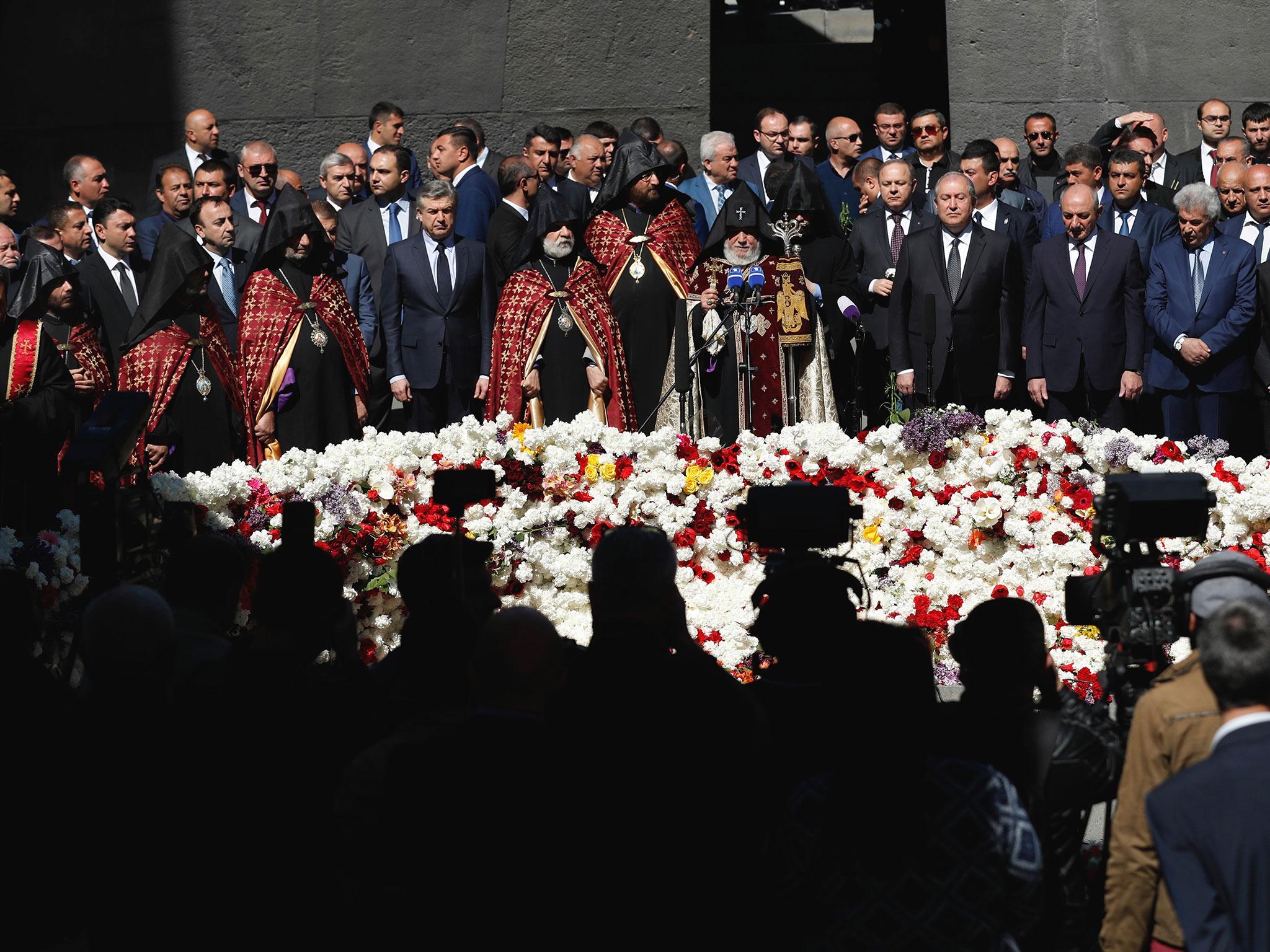 Armenian officials lay flowers at the monument to the victims of mass killings by Ottoman Turks