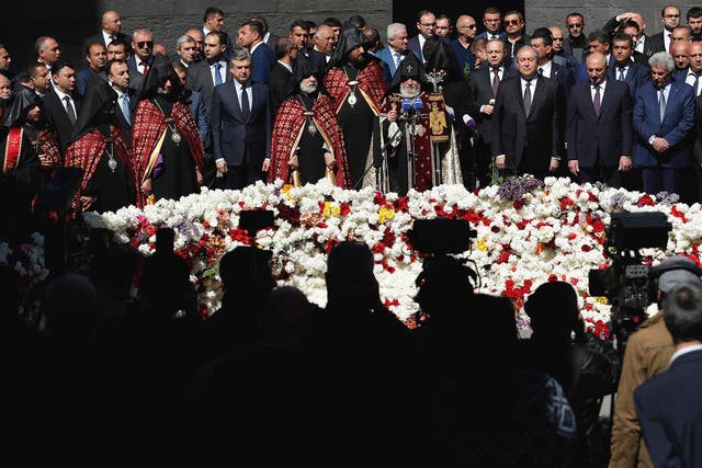 Armenian officials lay flowers at the monument to the victims of mass killings by Ottoman Turks