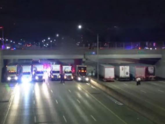 Police lined up lorries beneath the bridge to form a makeshift safety net