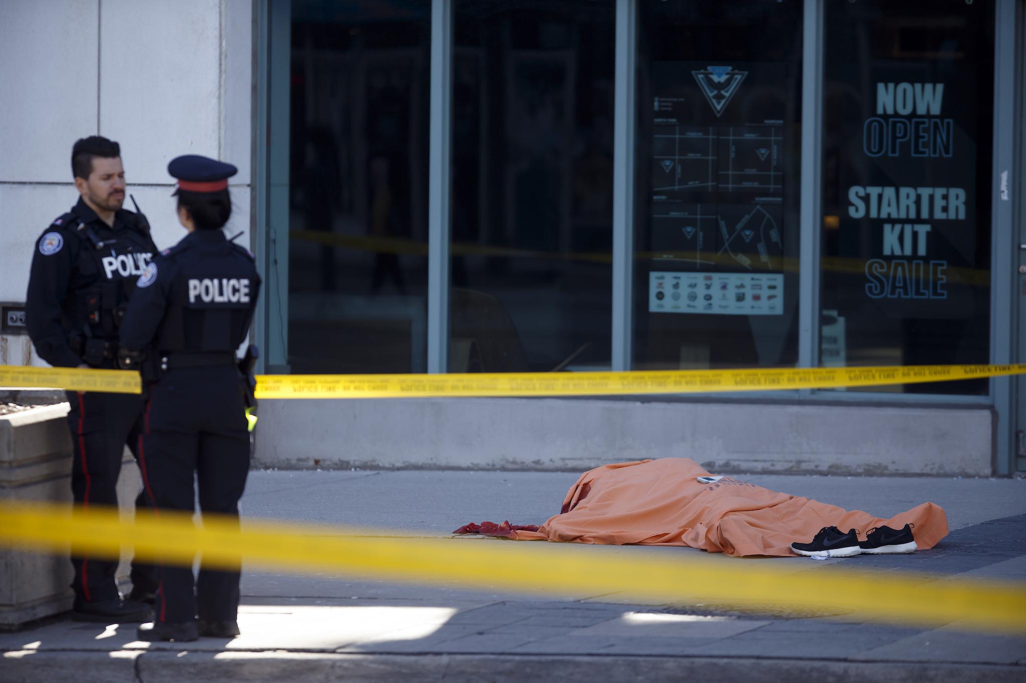A tarp covers an unidentiified body on Yonge St. at Finch Ave. after a van plowed into pedestrians on April 23, 2018 in Toronto, Ontario, Canada