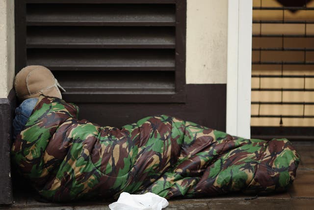 A homeless man sleeps near Trafalgar Square, London, in January 2016
