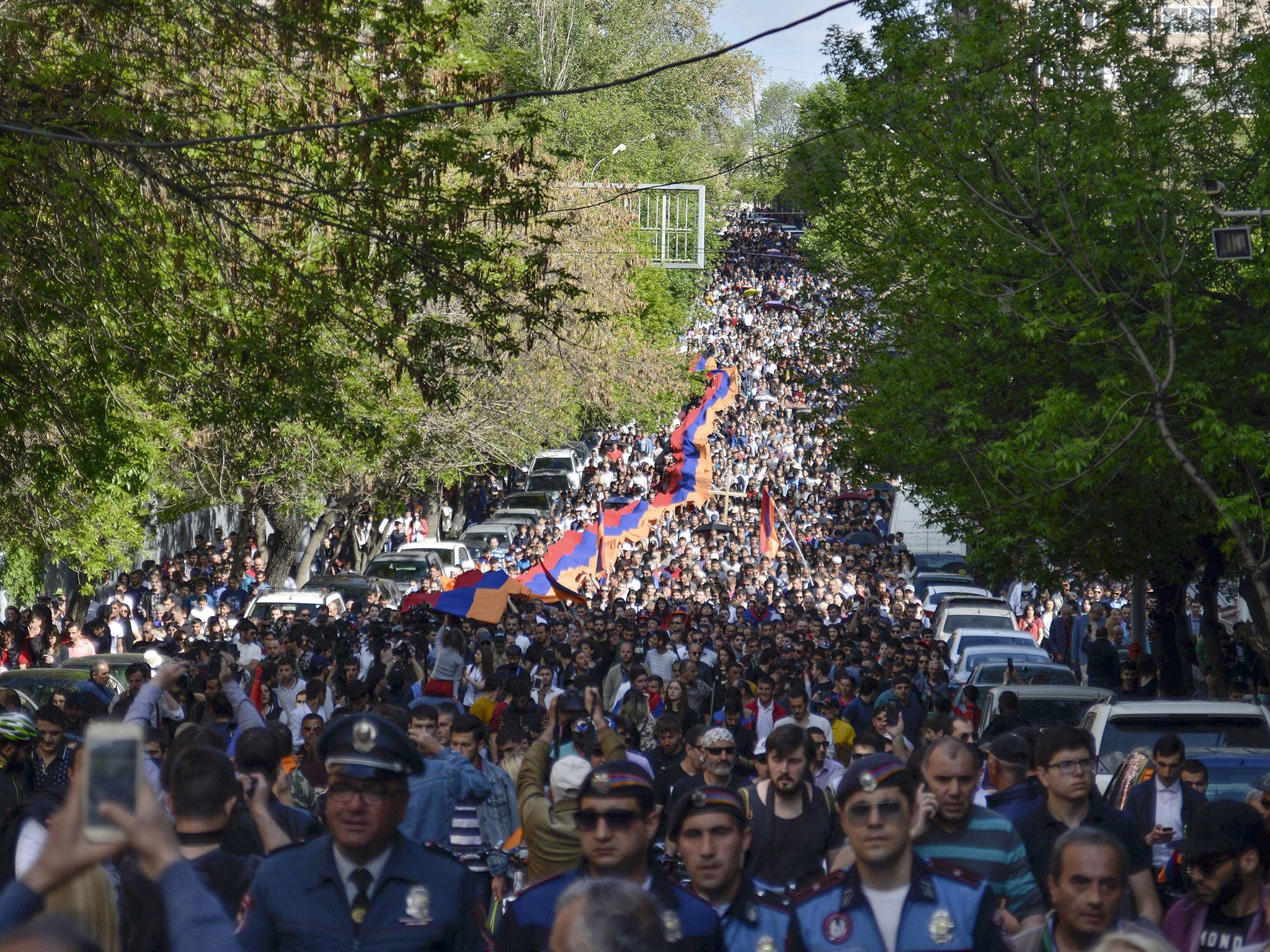 Armenians march to attend a memorial service at the monument to the victims of mass killings by Ottoman Turks, commemorating the 103rd anniversary of the genocide in Yerevan, Armenia