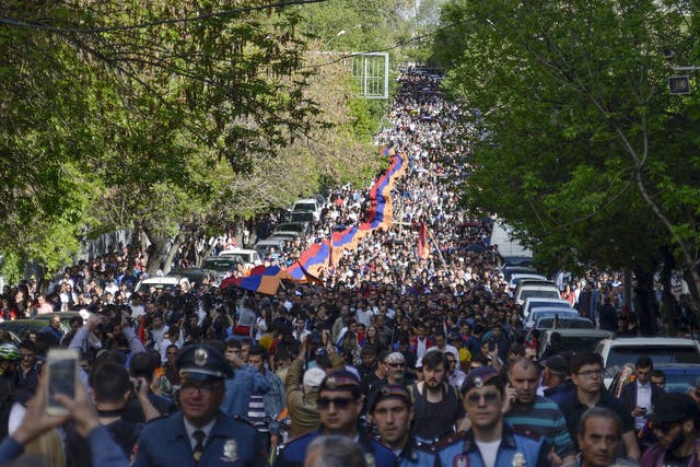 Armenians march to attend a memorial service at the monument to the victims of mass killings by Ottoman Turks, commemorating the 103rd anniversary of the genocide in Yerevan, Armenia