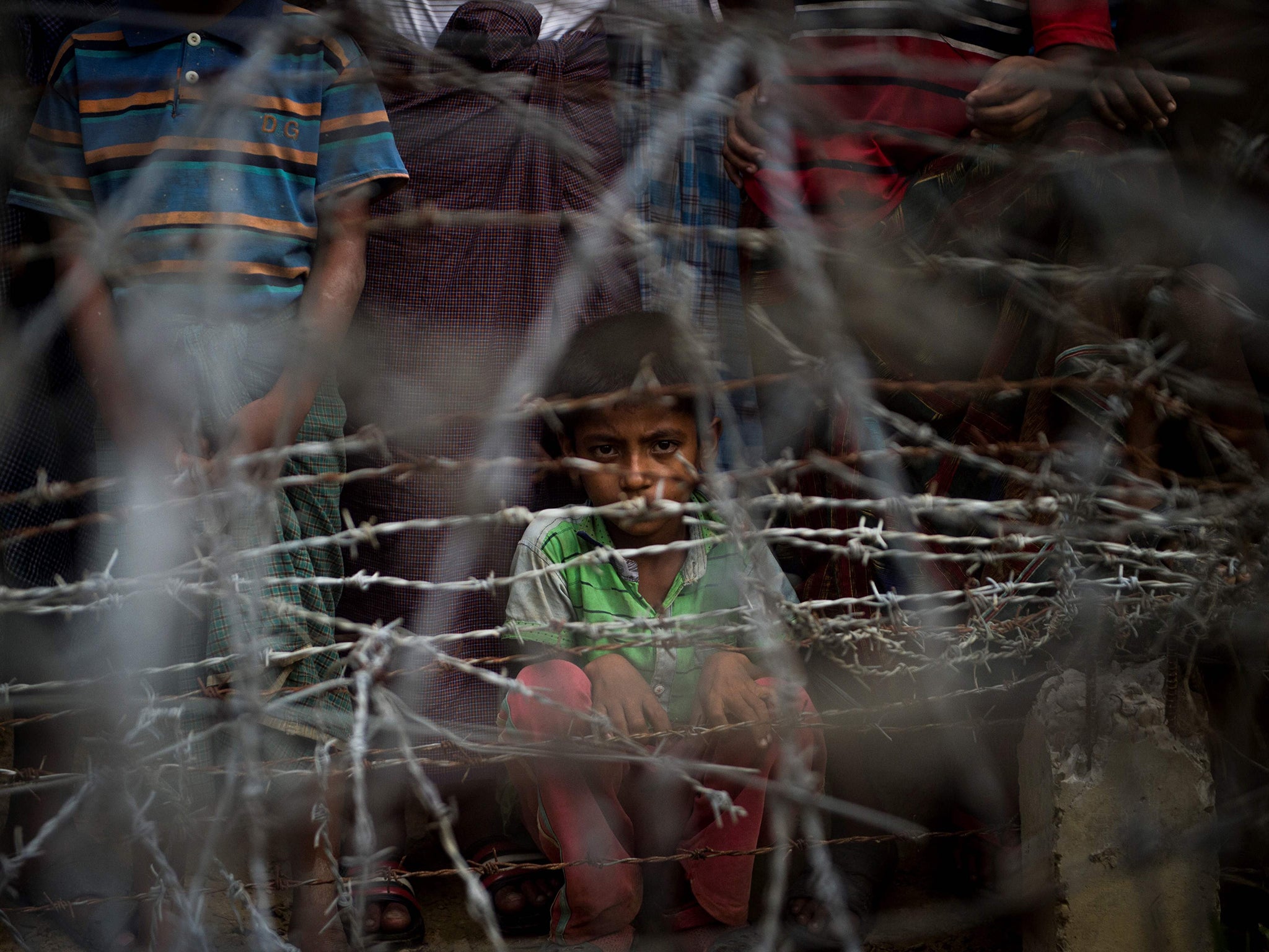 Rohingya refugees gather in the "no man's land" behind Myanmar's boder lined with barb wire fences in Maungdaw district, Rakhine state bounded by Bangladesh. Myanmar government said on April 15, it repatriated on April 14 the first family of Rohingya out of some 700,000 refugees who have fled a brutal military campaign, a move slammed by a rights group as a PR stunt ignoring UN warnings that a safe return is not yet possible.