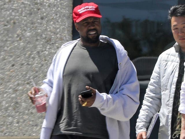 Kanye West leaves the studio wearing a ''Make America Great Again" hat following his recent Tweets on President Trump