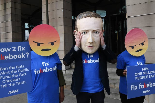 <p>A protester wears a mask of Facebook boss Mark Zuckerberg in 2018 </p>