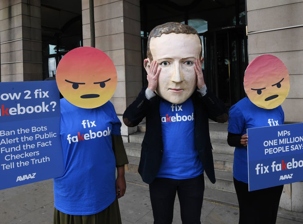 A protester wearing a mask depicting Facebook's CEO, Mark Zuckerberg, flanked by two protesters wearing angry emoji masks protest outside Portcullis House in central London. Facebook's CTO Mike Schroepfer appeared infront of British Members of Parliament on the Digital, Culture, Media and Sport Select Committee in the wake of allegations that information on millions of its users was misused.