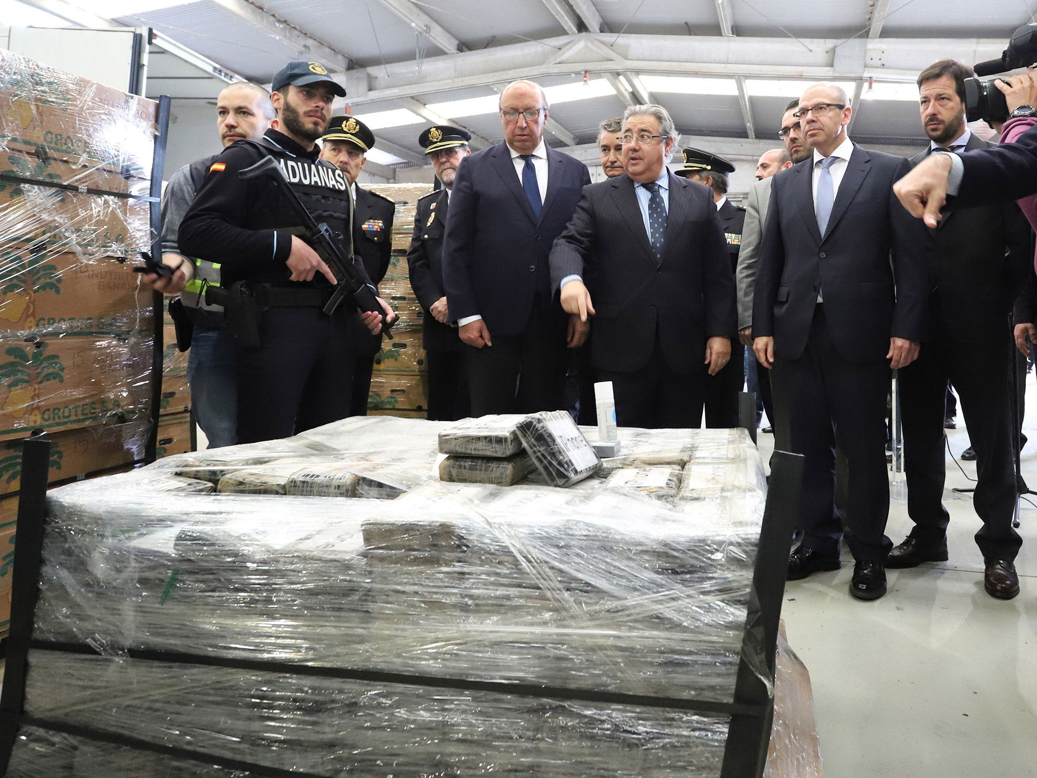 Spain's interior minister, Juan Ignacio Zoido, stands next to the almost nine tons cocaine shipment seized inside a bananas container at Algeciras port in Cadiz, southern Spain