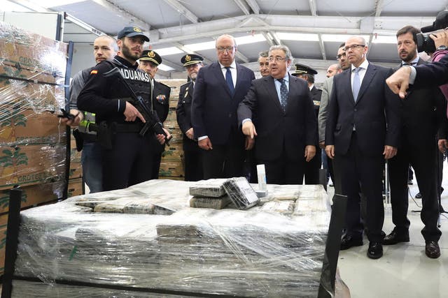 Spain's interoir minister, Juan Ignacio Zoido, stands next to the almost nine tons cocaine shipment seized inside a bananas container at Algeciras port in Cadiz, southern Spain