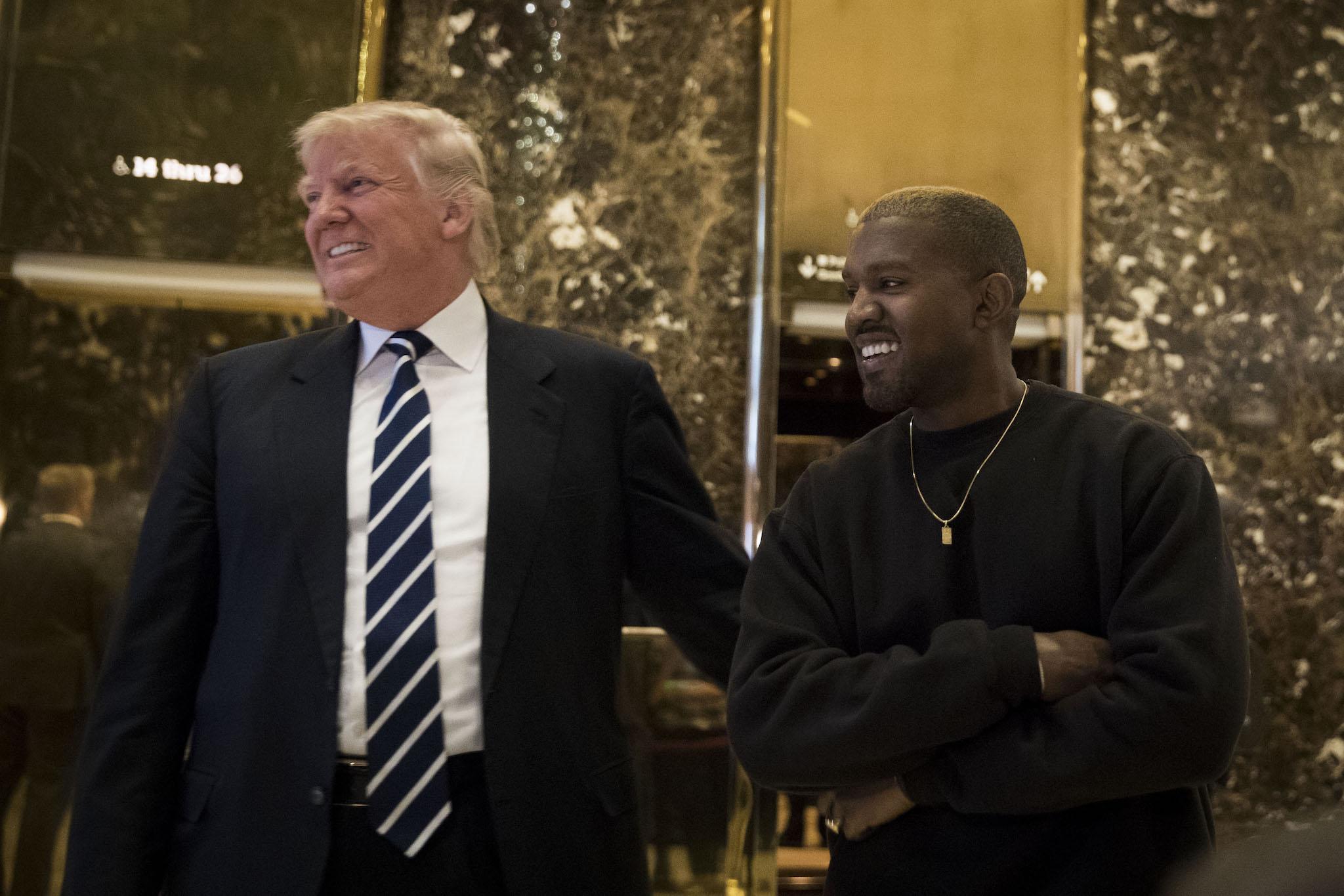 President-elect Donald Trump and Kanye West stand together in the lobby at Trump Tower, December 13, 2016 in New York City
