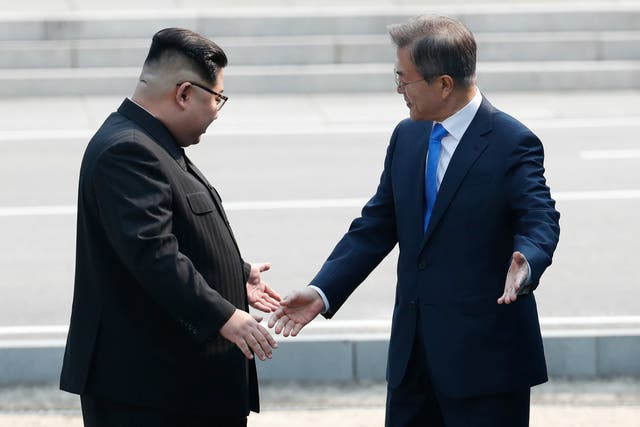 North Korean leader Kim Jong Un (L) and South Korean President Moon Jae-in (R) shake hands upon meeting for the Inter-Korean Summit